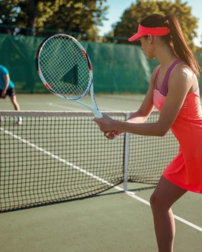 couple-playing-tennis-on-outdoor-court.jpg